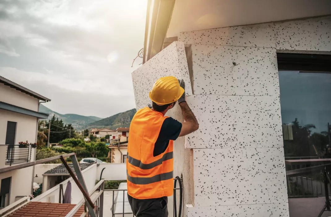 Smart radiation-assisted Tunable PCM Dynamic Insulation Wall (rTPDW) for building energy saving and decarbonization 